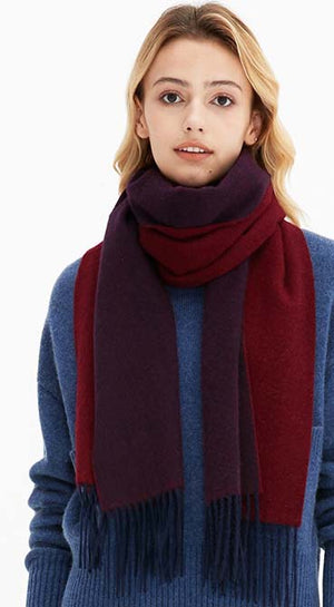 a women in wine red scarf and blue sweater